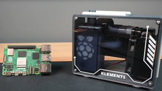 Michael Klements' custom Raspberry Pi 5 case with Pi 5 open loop rebuilt within hyper compact case, beside a regular Pi 5.